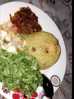 A picture of Fried rice with salad and sauce.