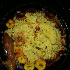 A picture of Fried rice plantains and fried chicken.