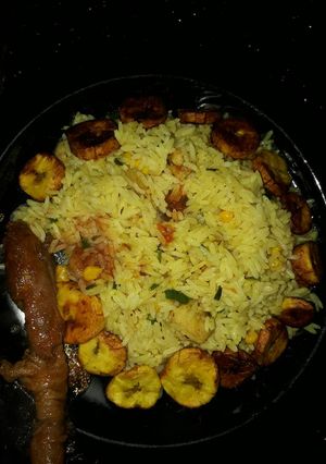 A picture of Fried rice plantains and fried chicken.