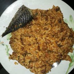 A picture of Rice and beans porriage with fried fish.