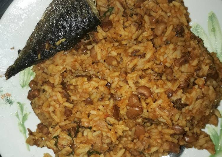 Rice and beans porriage with fried fish