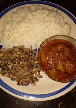 A picture of White rice beans and stew.