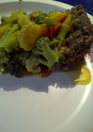 A picture of Meatloaf Pizza, on the stove top.
