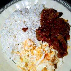 A picture of Rice stew and coleslaw.