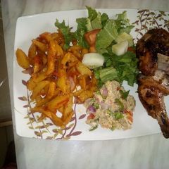 A picture of Sauteed potatoes with scrambled eggs and grilled chicken.