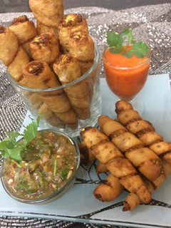 A picture of Baby corn twister with salsa sauce.