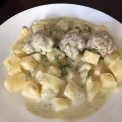 A picture of Meatballs in white sauce.