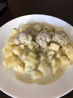 A picture of Meatballs in white sauce.