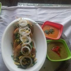 A picture of Suji Kachori with Red... Green... chutney.