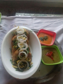 A picture of Suji Kachori with Red... Green... chutney.