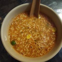 A picture of Tomato with noodles soup.