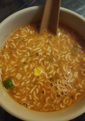 A picture of Tomato with noodles soup.