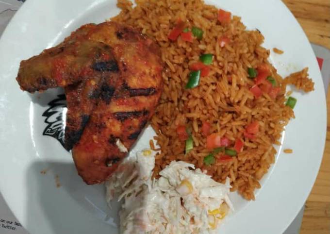 Jollof rice with coleslaw and fried chicken