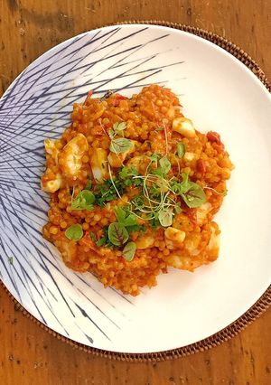 A picture of Fregola sarda with prawns, squid, scallops, blue eye cod and light tomato sauce.