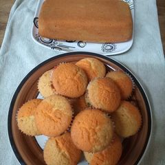 A picture of Bubble gum and orange cupcakes and loaf cake.