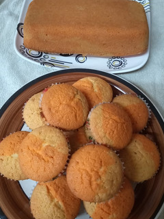 A picture of Bubble gum and orange cupcakes and loaf cake.
