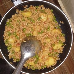 A picture of Fried rice with green peas.