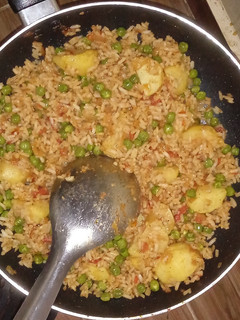 A picture of Fried rice with green peas.