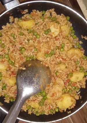 A picture of Fried rice with green peas.