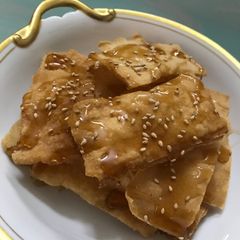 A picture of Fried Egg Roll Wraps with Syrup.