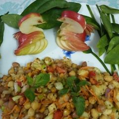 A picture of Chickpea fruits veggies and nuts salad.