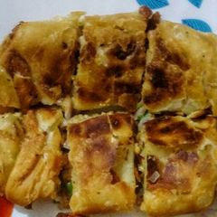 A picture of Moghlai Paratha/Egg Paratha.
