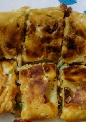 A picture of Moghlai Paratha/Egg Paratha.
