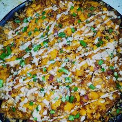 A picture of Chicken bacon Butter garlic shrimp Asian style nachos.