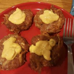 A picture of Potato cakes with corned beef and cheese.
