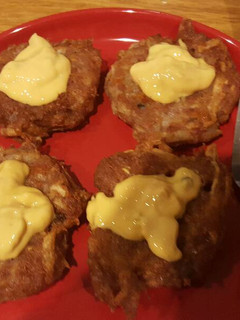 A picture of Potato cakes with corned beef and cheese.