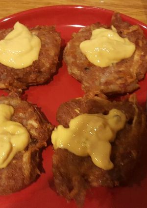 A picture of Potato cakes with corned beef and cheese.