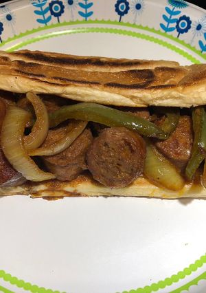 A picture of Bite Sized Baked Sausages with Peppers and Onions.