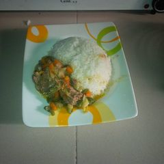 A picture of White rice with chicken sauce.
