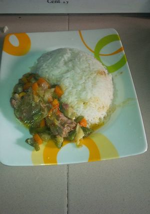 A picture of White rice with chicken sauce.