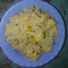 A picture of Rice with ndengu and potatoes.