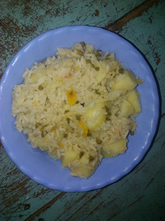 A picture of Rice with ndengu and potatoes.