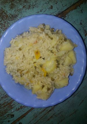 A picture of Rice with ndengu and potatoes.