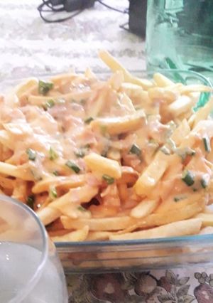 Una foto de Papas con cheddar