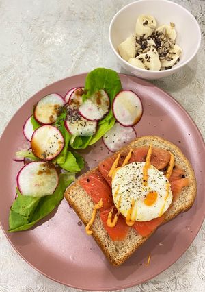 A picture of Smoked salmon toast with radish salad and healthy side dish.