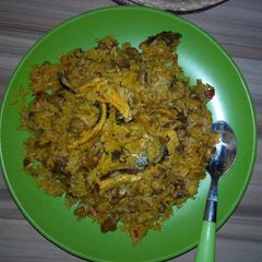 A picture of Jollof rice and beans with locustbeans cake(Daddawa).