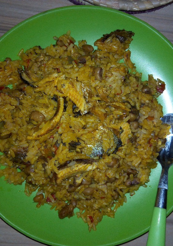 A picture of Jollof rice and beans with locustbeans cake(Daddawa).
