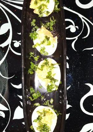A picture of Boiled Egg with masala yolk.
