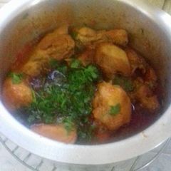 A picture of Chicken stew with sprinkled Coriander.