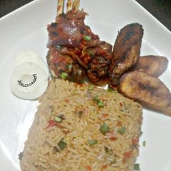 A picture of Peppered Ram meat and jallof rice.