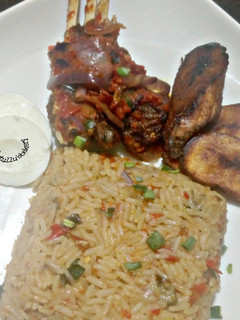 A picture of Peppered Ram meat and jallof rice.