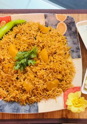 A picture of Patato rice with raita and salad.