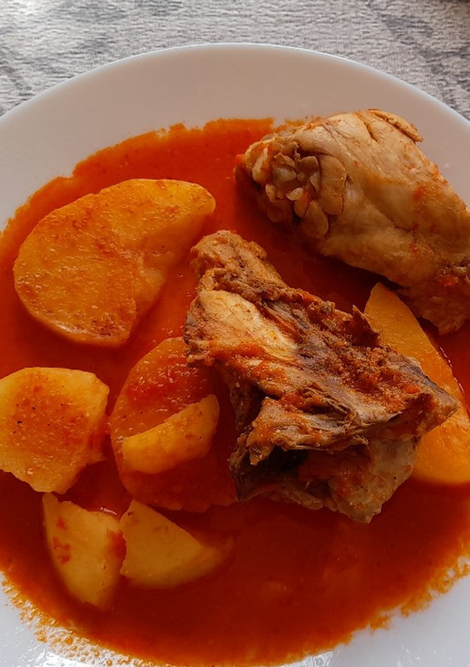 Una foto de Pollo con patatas guisadas en salsa de pimientos rojos