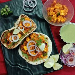 A picture of Paneer tikka masala in naan tacos.