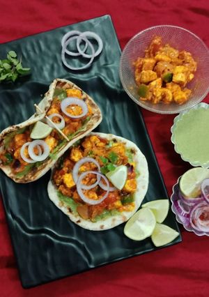 A picture of Paneer tikka masala in naan tacos.