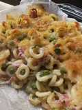 Anelletti siciliani al forno con piselli e prosciutto cotto